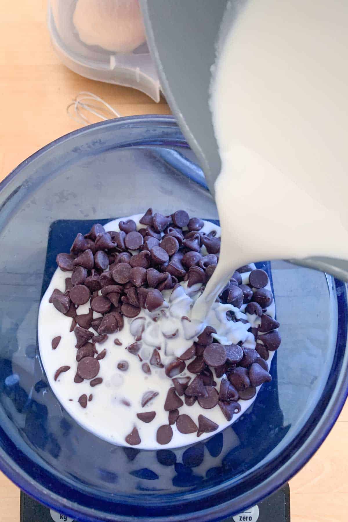 pouring cream over chocolate chips for ganache