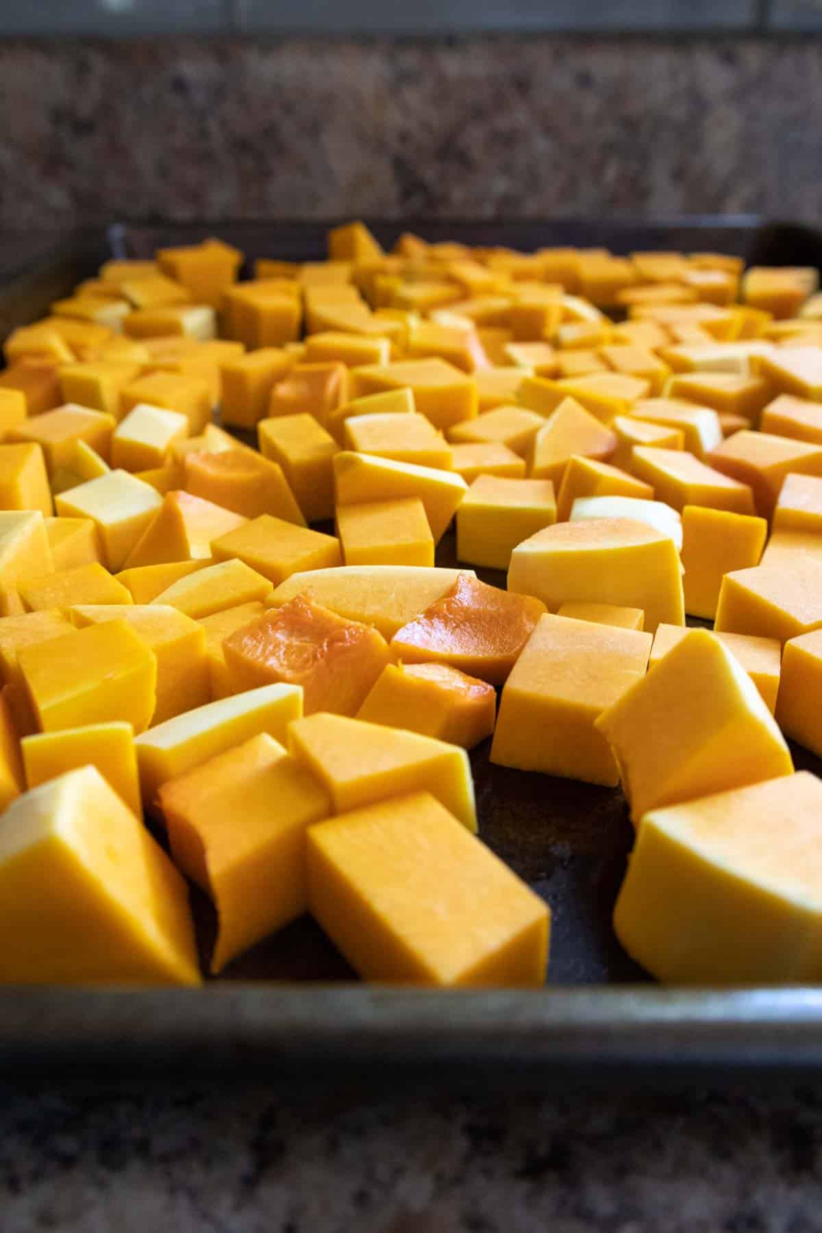 butternut squash cubes on baking sheet