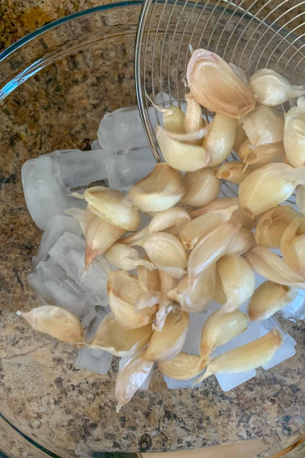 pouring boiled garlic into ice bath