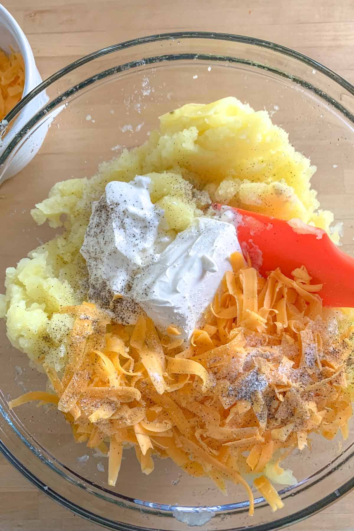 ingredients for twice baked mashed potatoes in a bowl for mixing