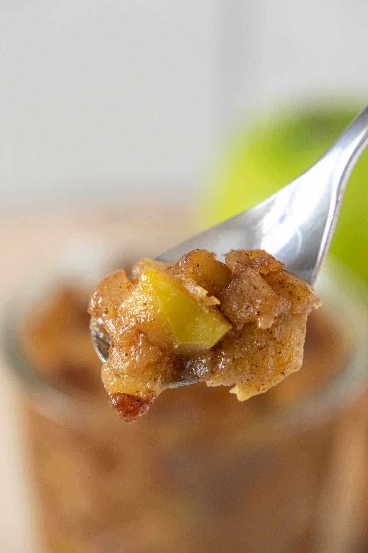 Close up of a spoonful of apple compote.