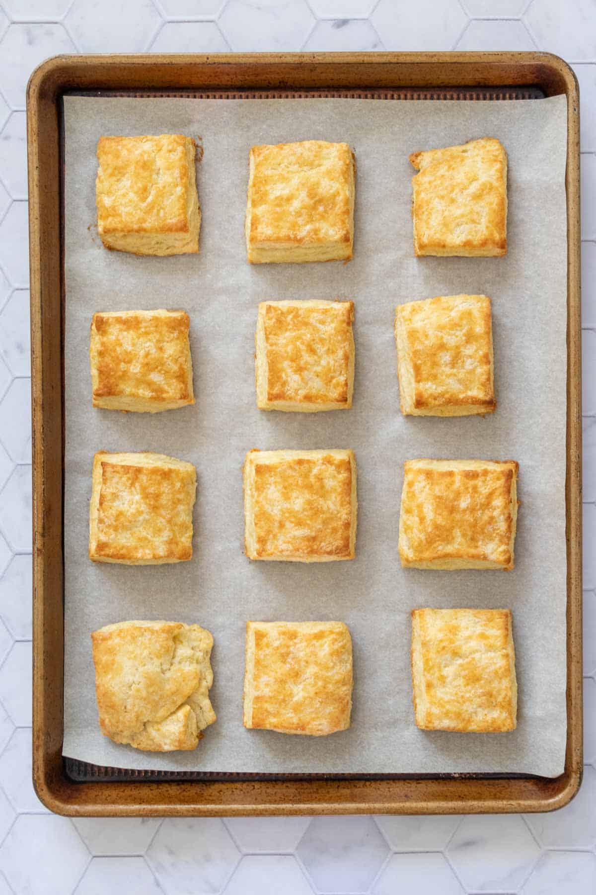 Sheet pan with baked buttermilk biscuits on it.