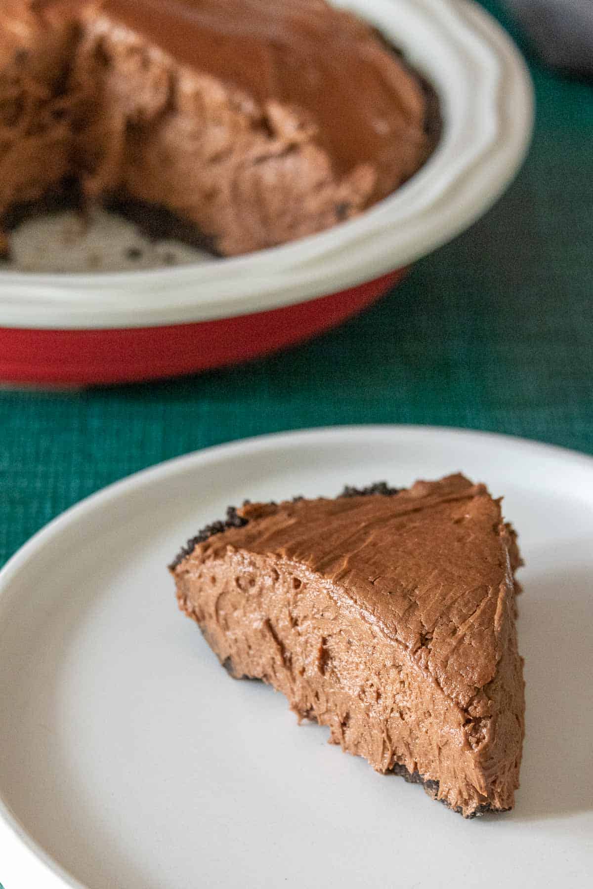 Slice of chocolate peanut butter pie on a white plate.