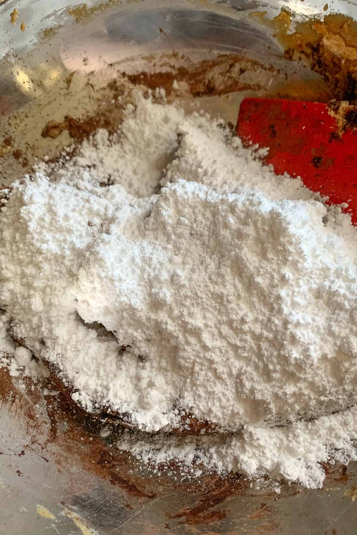 Powdered sugar being added to pie filling.