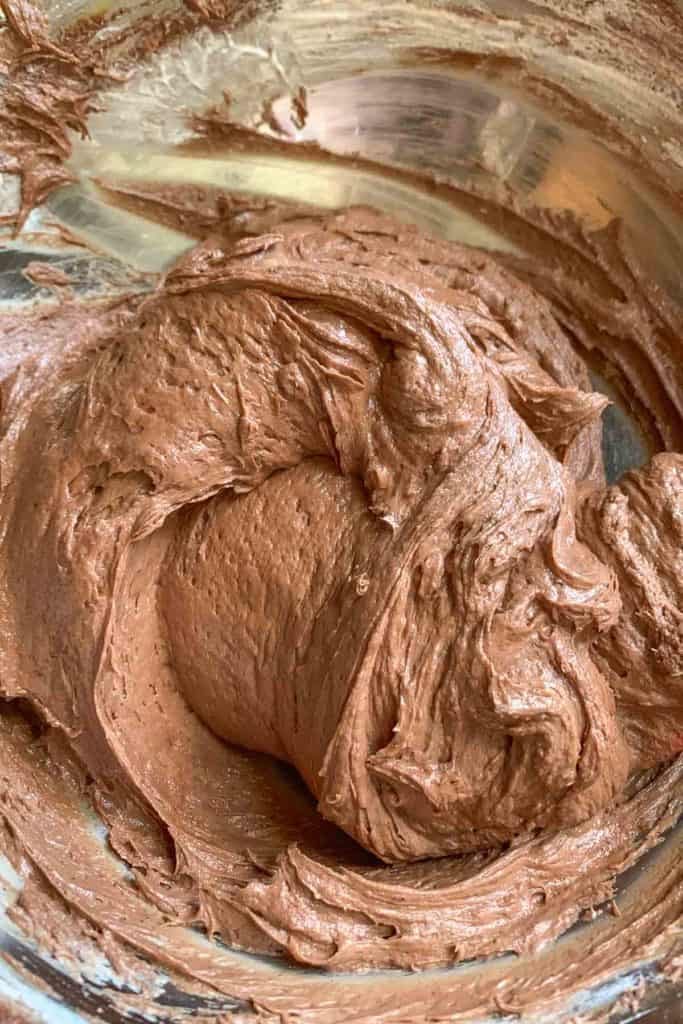 Chocolate peanut butter pie filling in a silver mixing bowl.