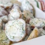 Dill potatoes in a white serving dish.