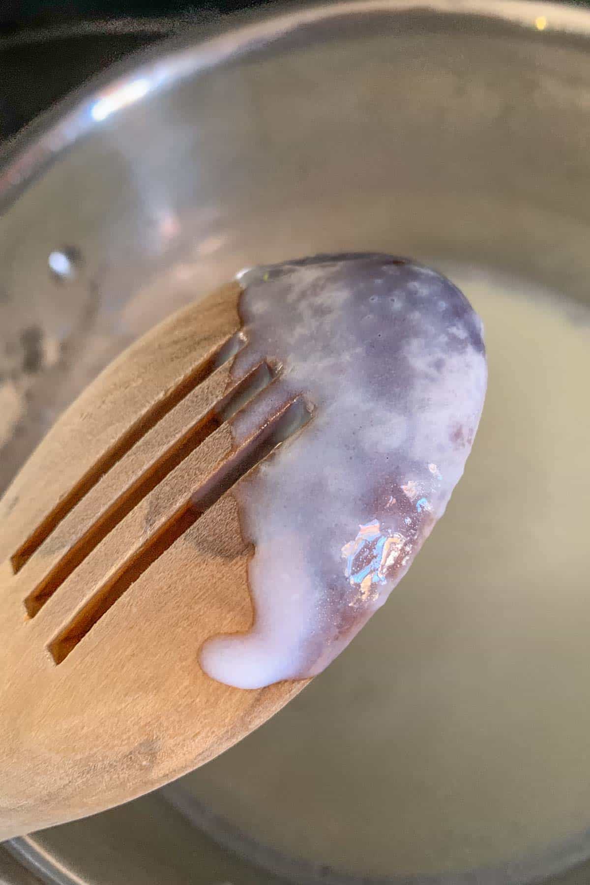 Spoon showing sauce lightly coating it.