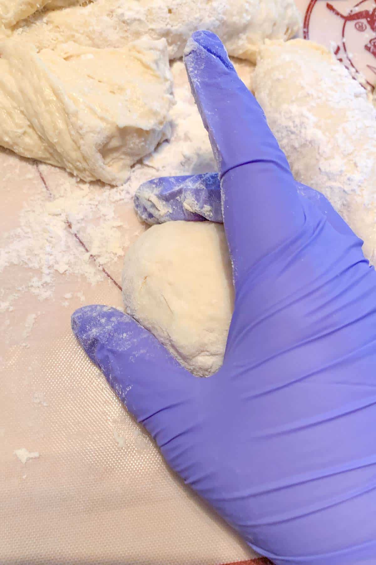 Rolling English muffin dough into balls.