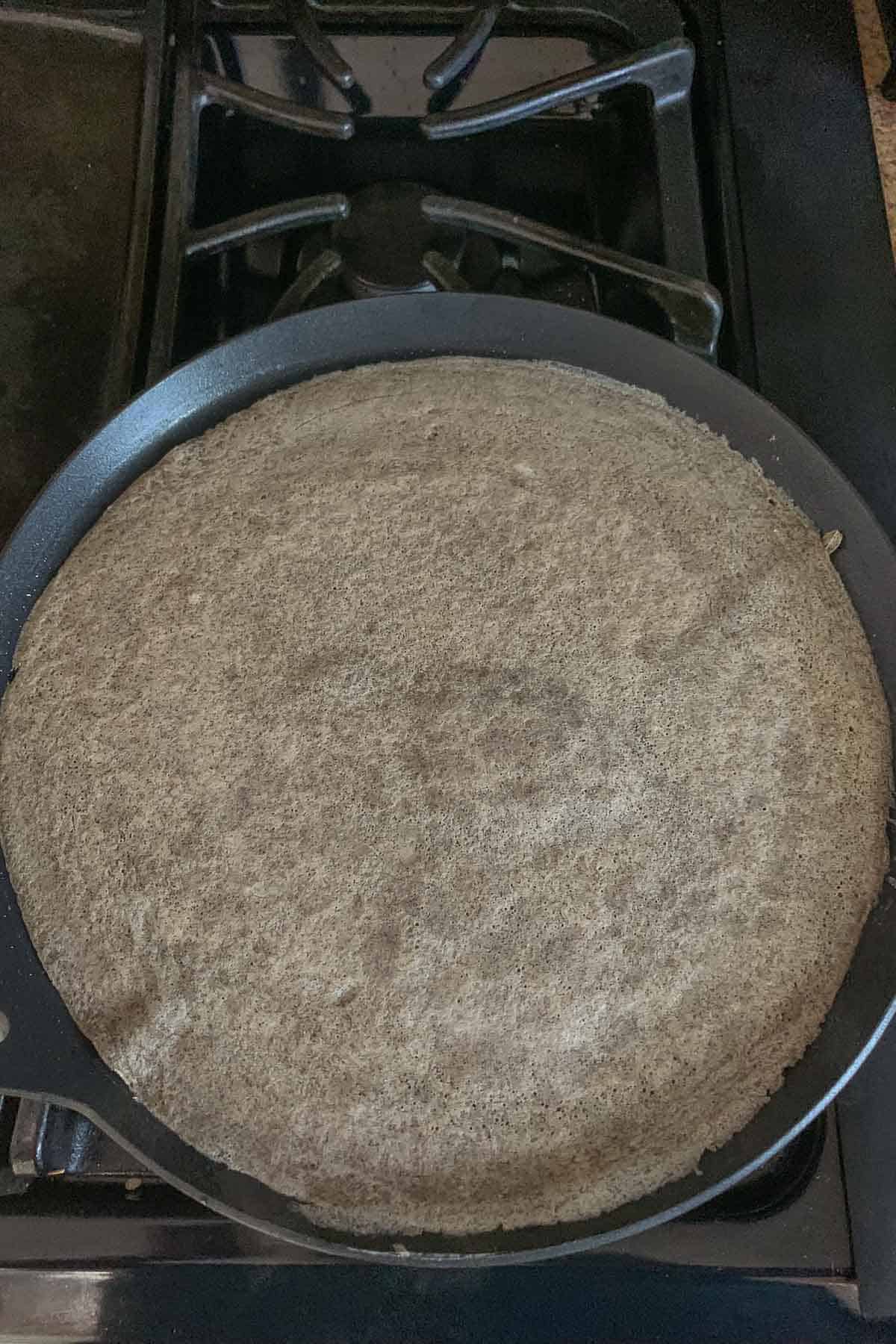 Cooked buckwheat crepe on pan.