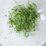 Dried chive pieces in a bowl.