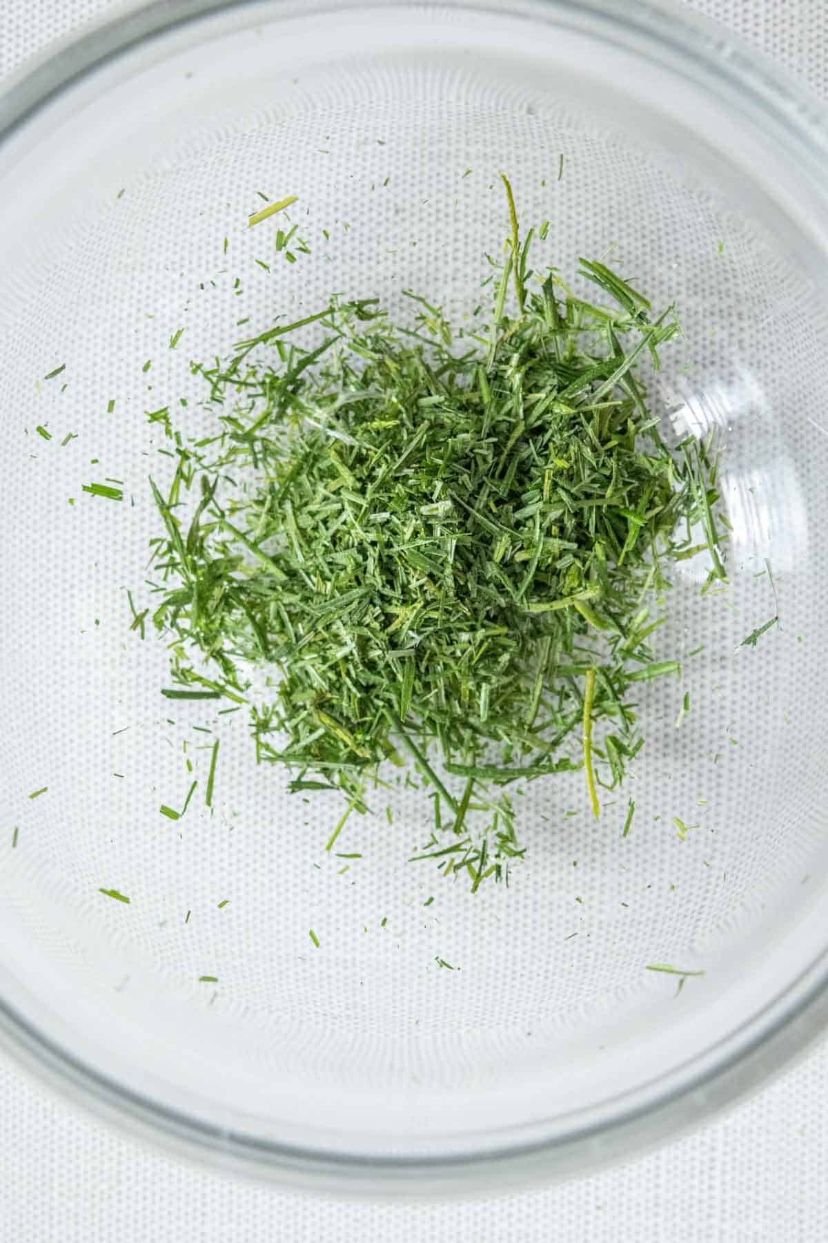 Dried chive pieces in a bowl.