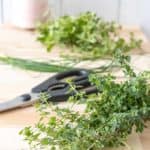 Herbs on a cutting board to be prepped for drying.