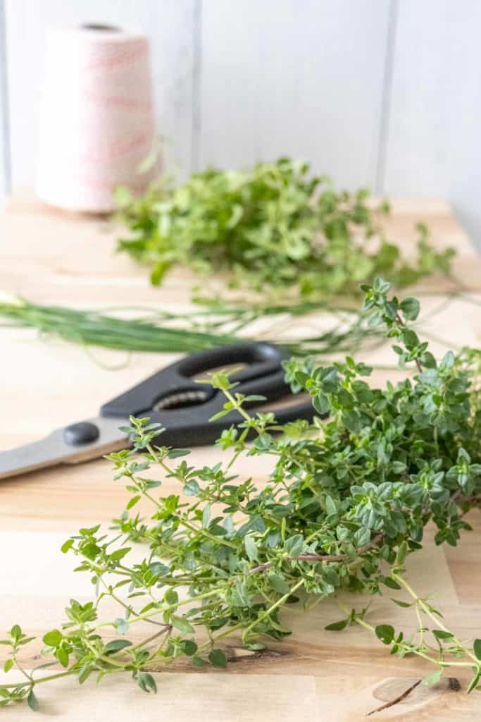 Herbs on a cutting board to be prepped for drying.