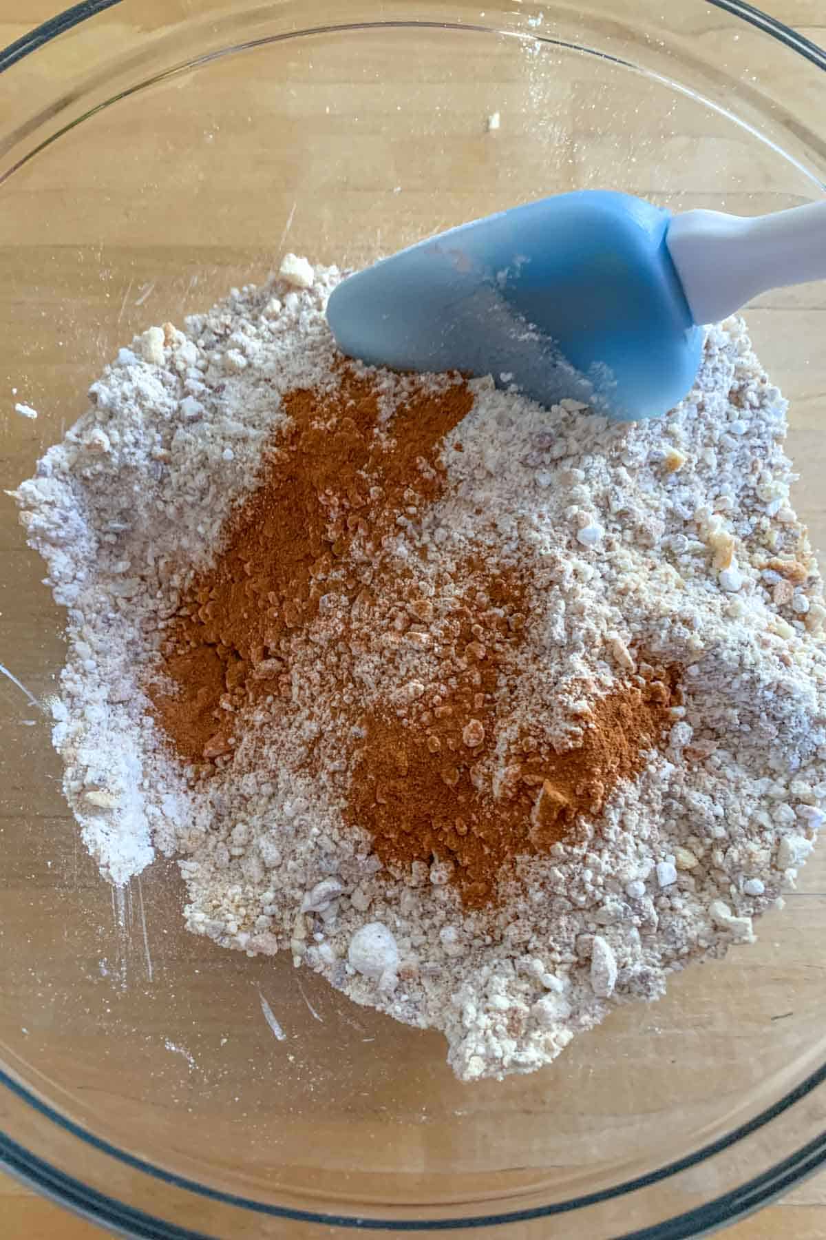 Adding cinnamon to dry mixture for bourbon balls.