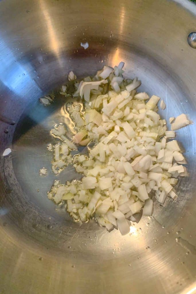 Cooking shallot in melted butter.