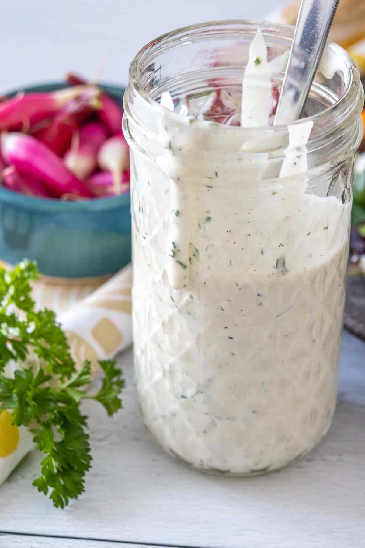 Ranch dressing in a glass jar.