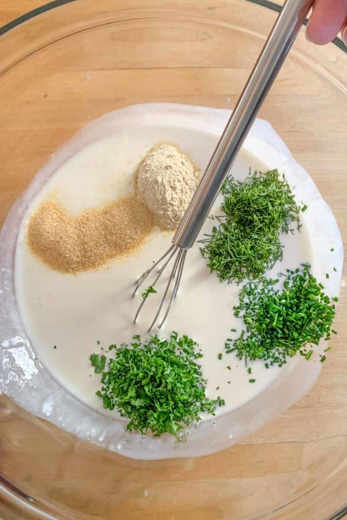 Mixing together ingredients for ranch dressing.