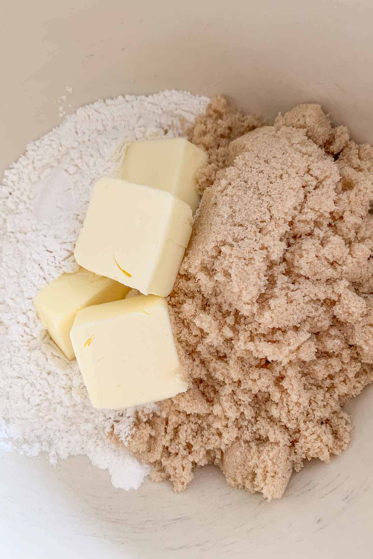 Flour, butter, and brown sugar in a mixing bowl.