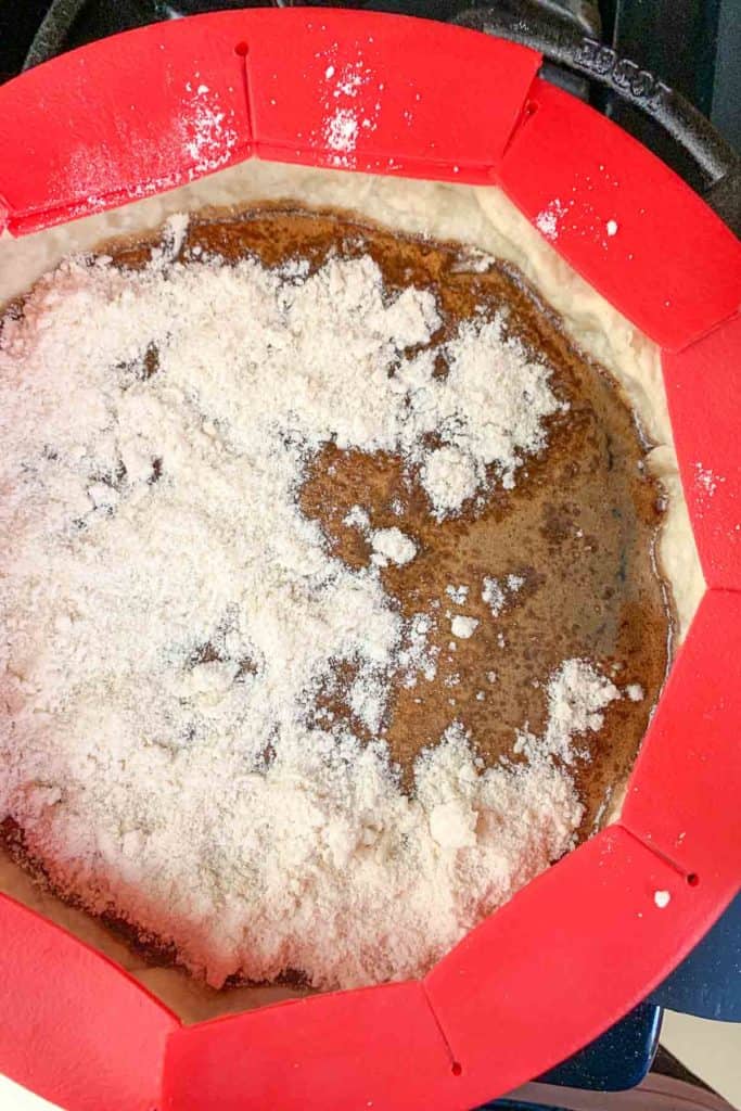 Adding dry topping to unbaked shoofly pie.