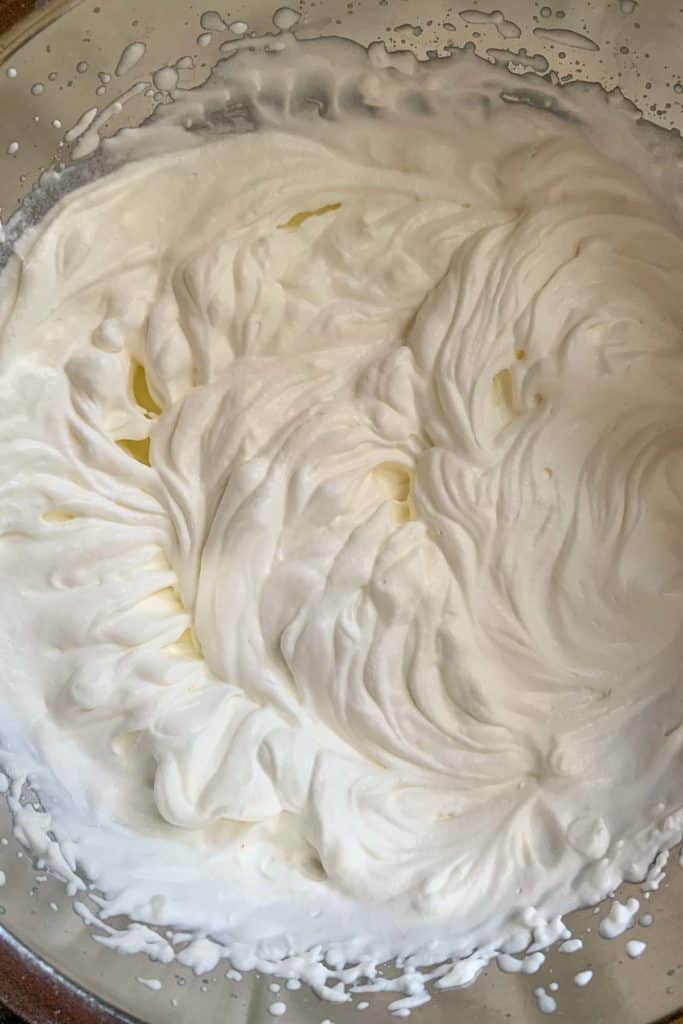 Whipped cream in a metal bowl.