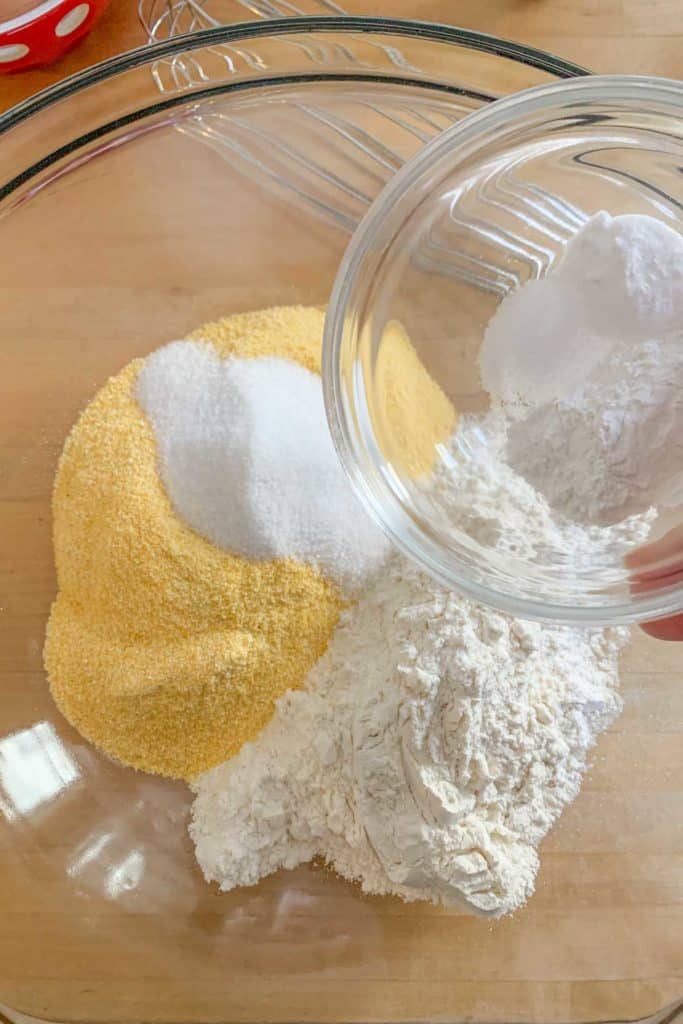Glass mixing bowl with dry ingredients for blueberry pancakes.