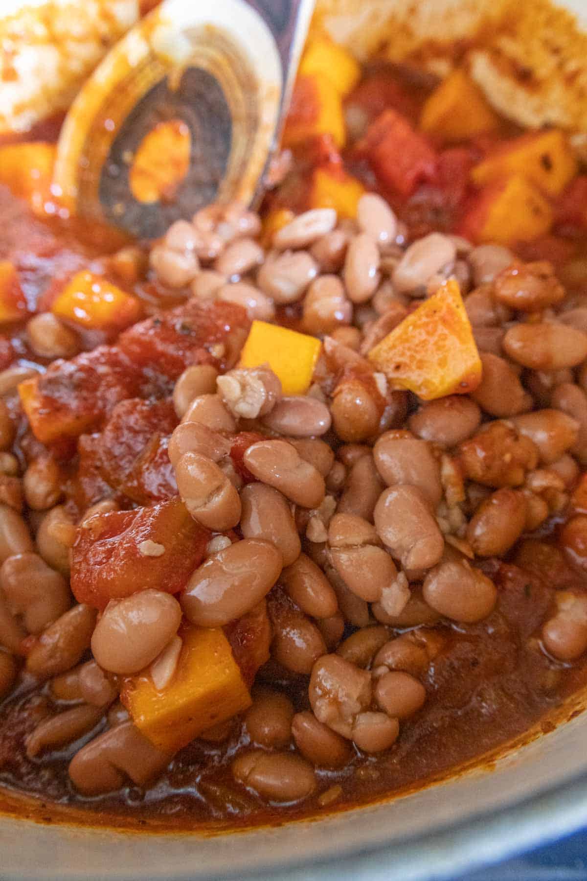 Beans being added to chili.