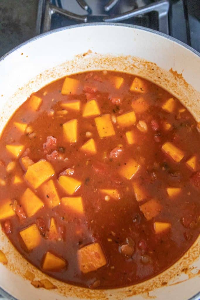 Butternut squash chili in dutch oven on stove.