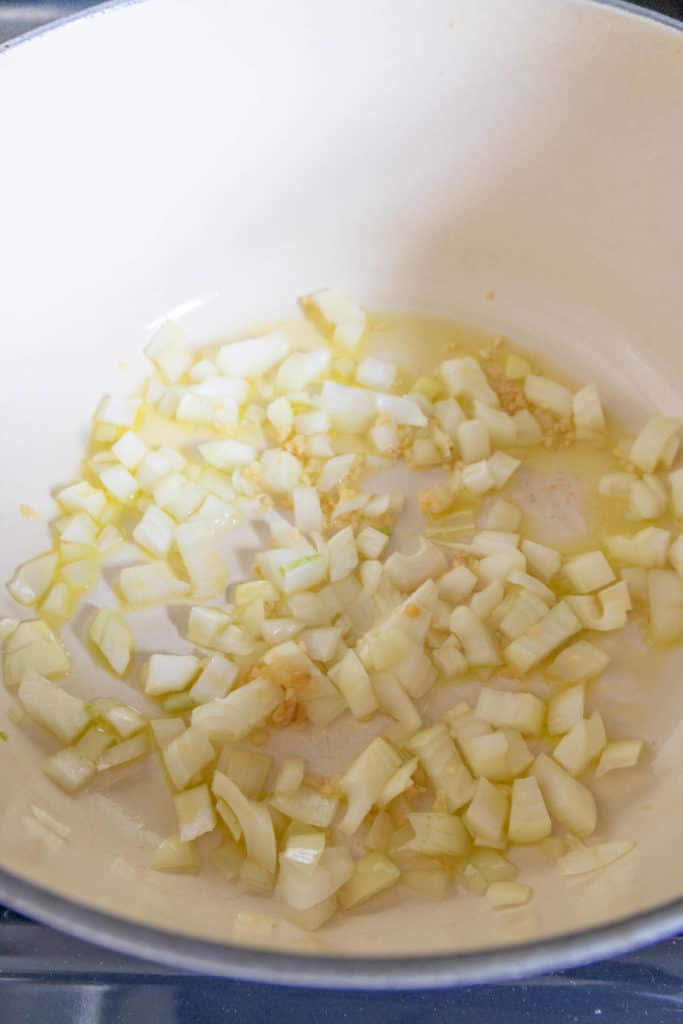 Onion and garlic sauteeing in dutch oven.