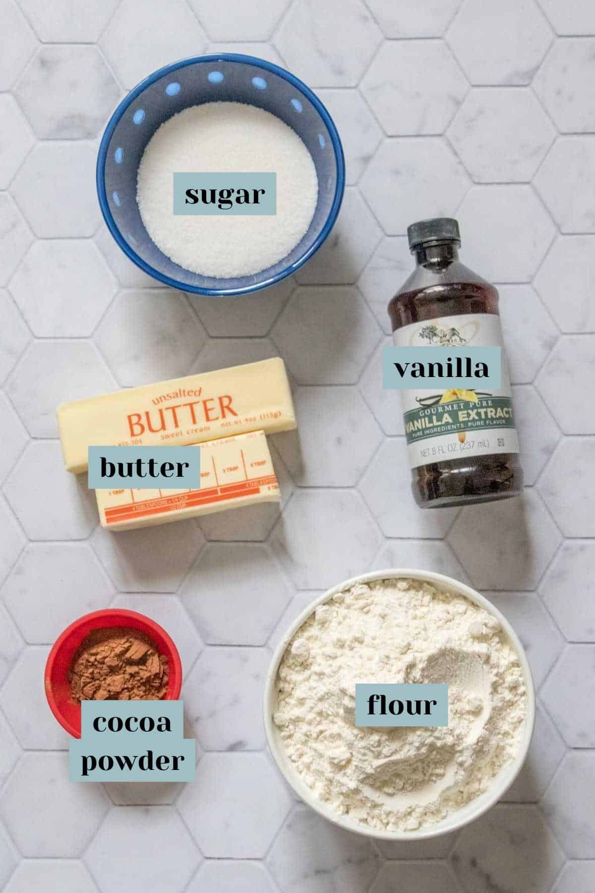 Ingredients for checkerboard cookies on a tile surface with labels.