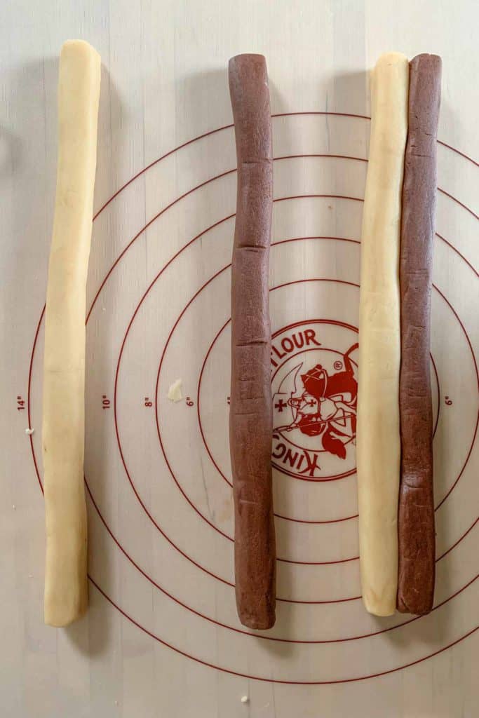 Shaped logs of checkerboard cookie dough.