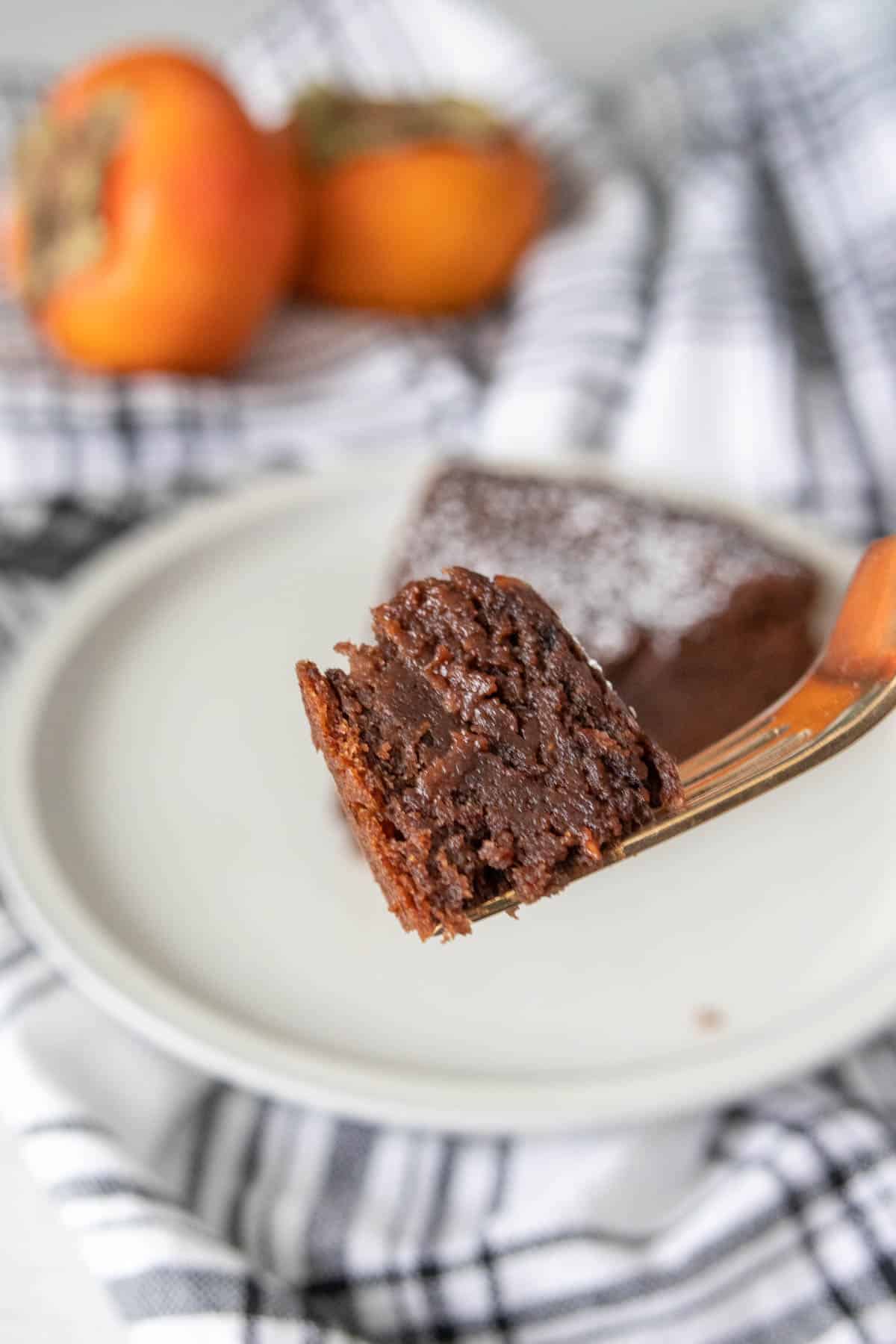 Bite of chocolate persimmon cake on a fork.
