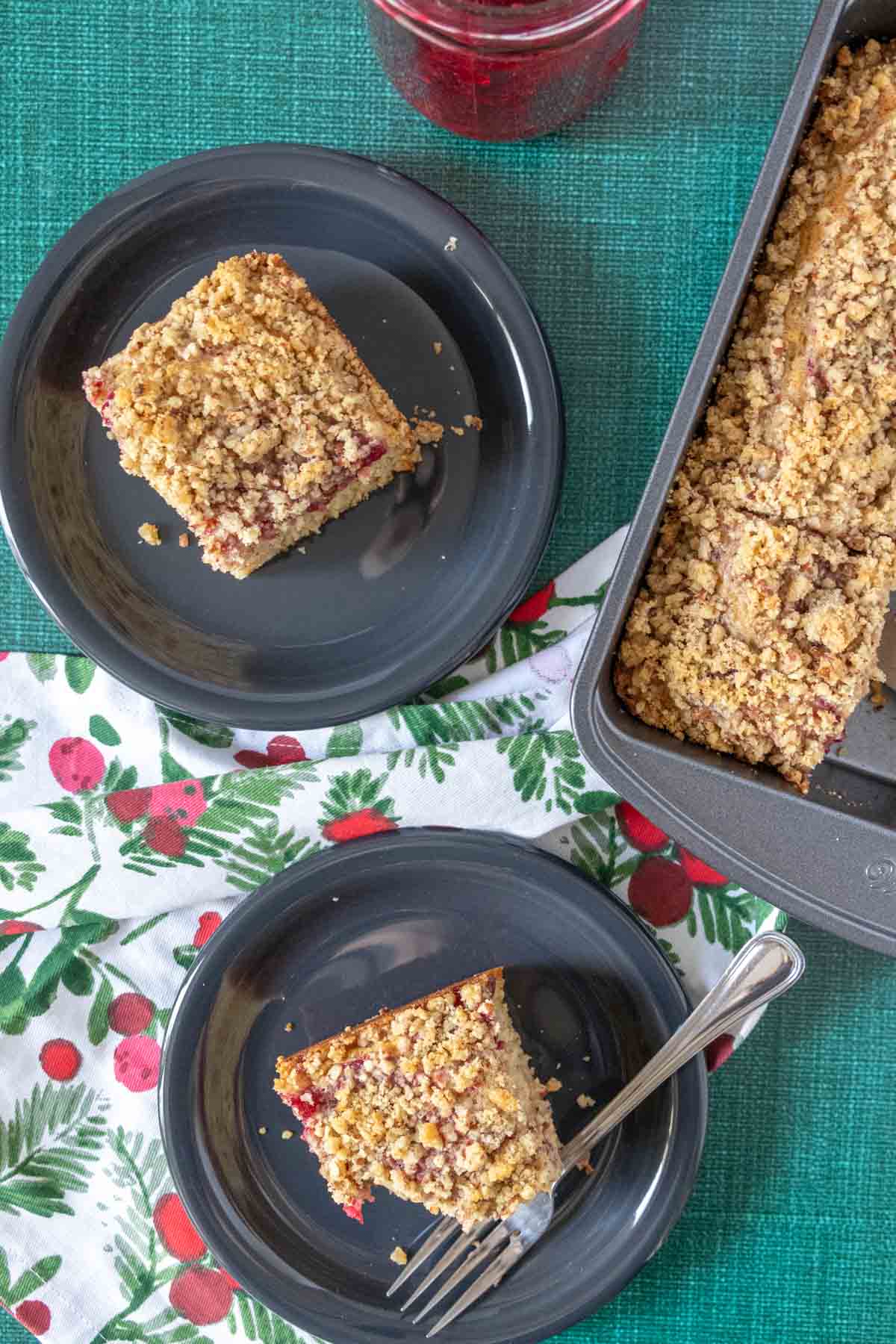 Overhead of cranberry coffee cake served onto black plates.