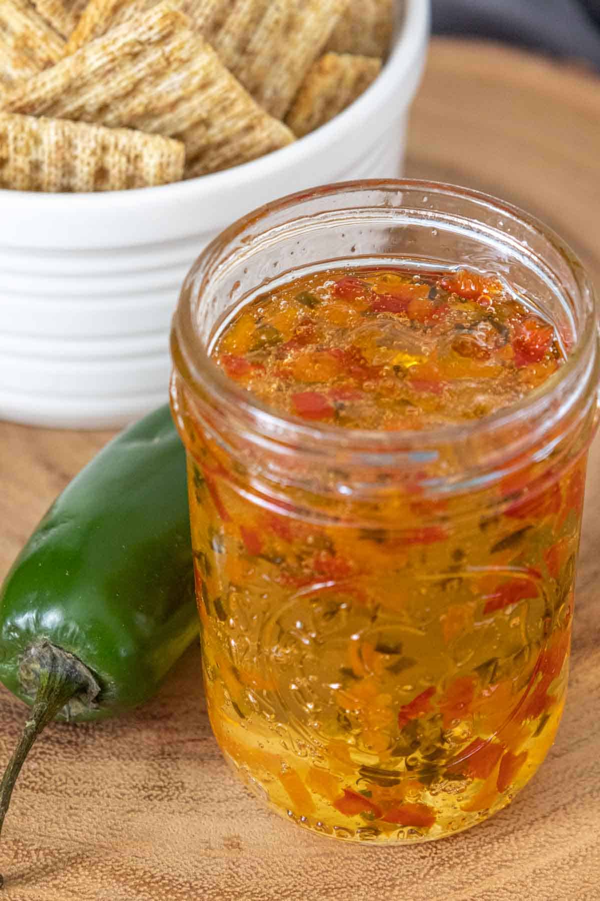 Jar of jalapeño jelly with the lid off so you can see inside the jar.