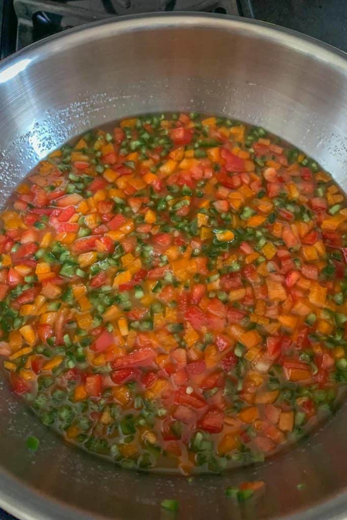 Cooking jalapeño jelly in a stainless pan.