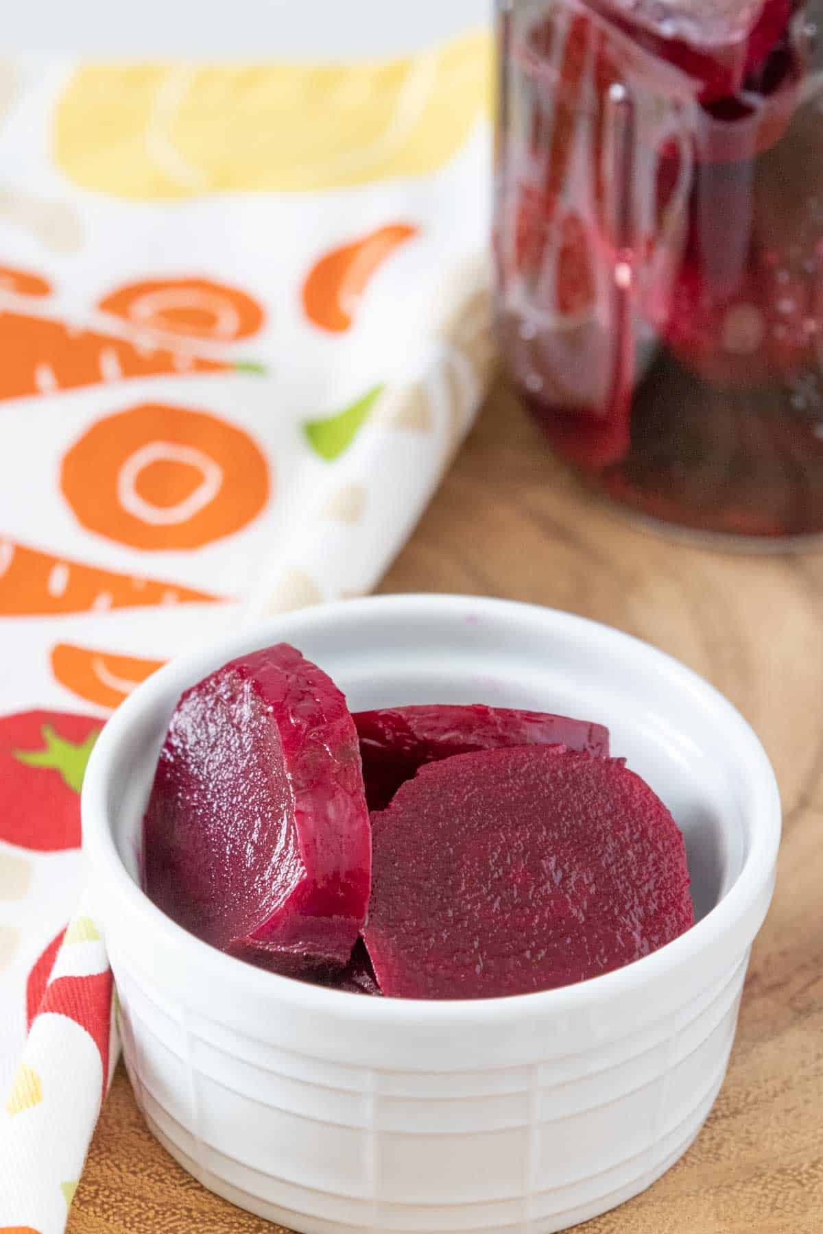 White bowl of pickled beets.