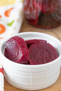 White bowl with pickled beets.