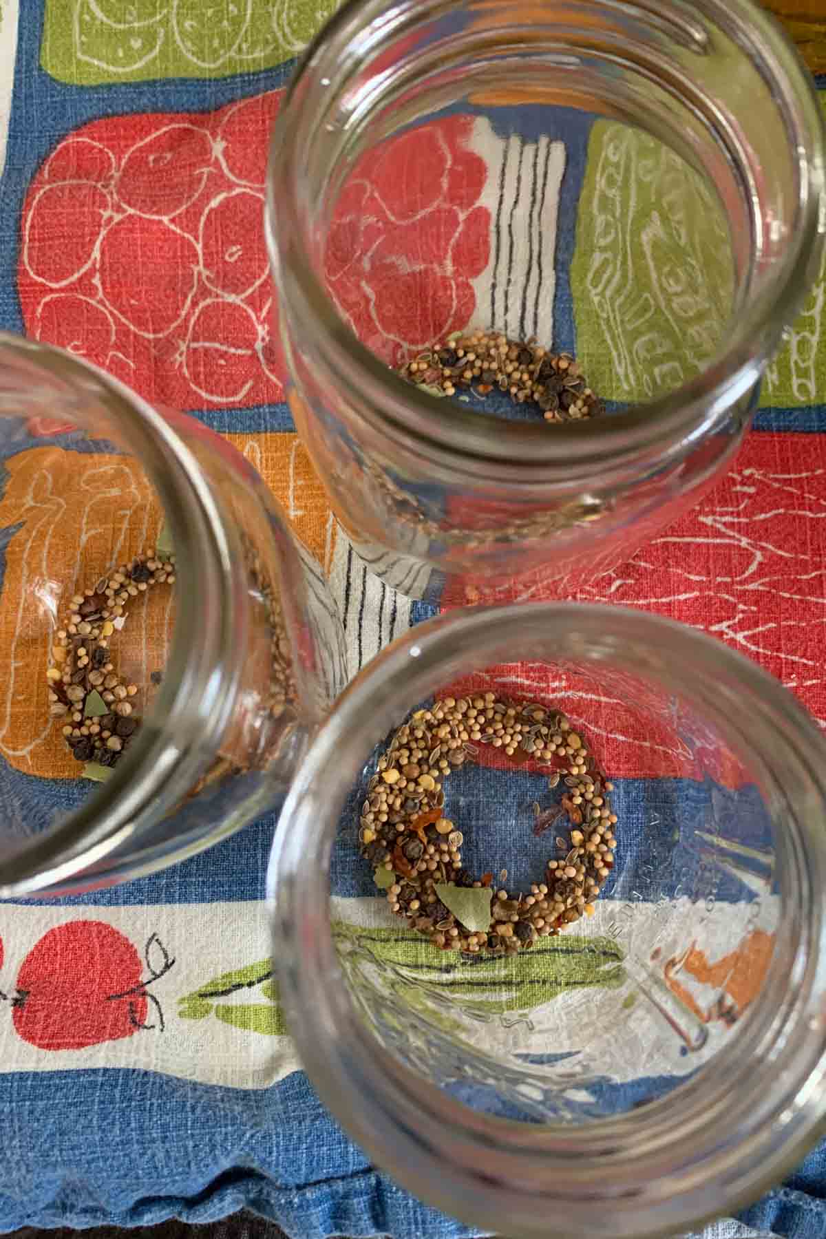 Overhead of jars with pickling spices in them for pickled beets.