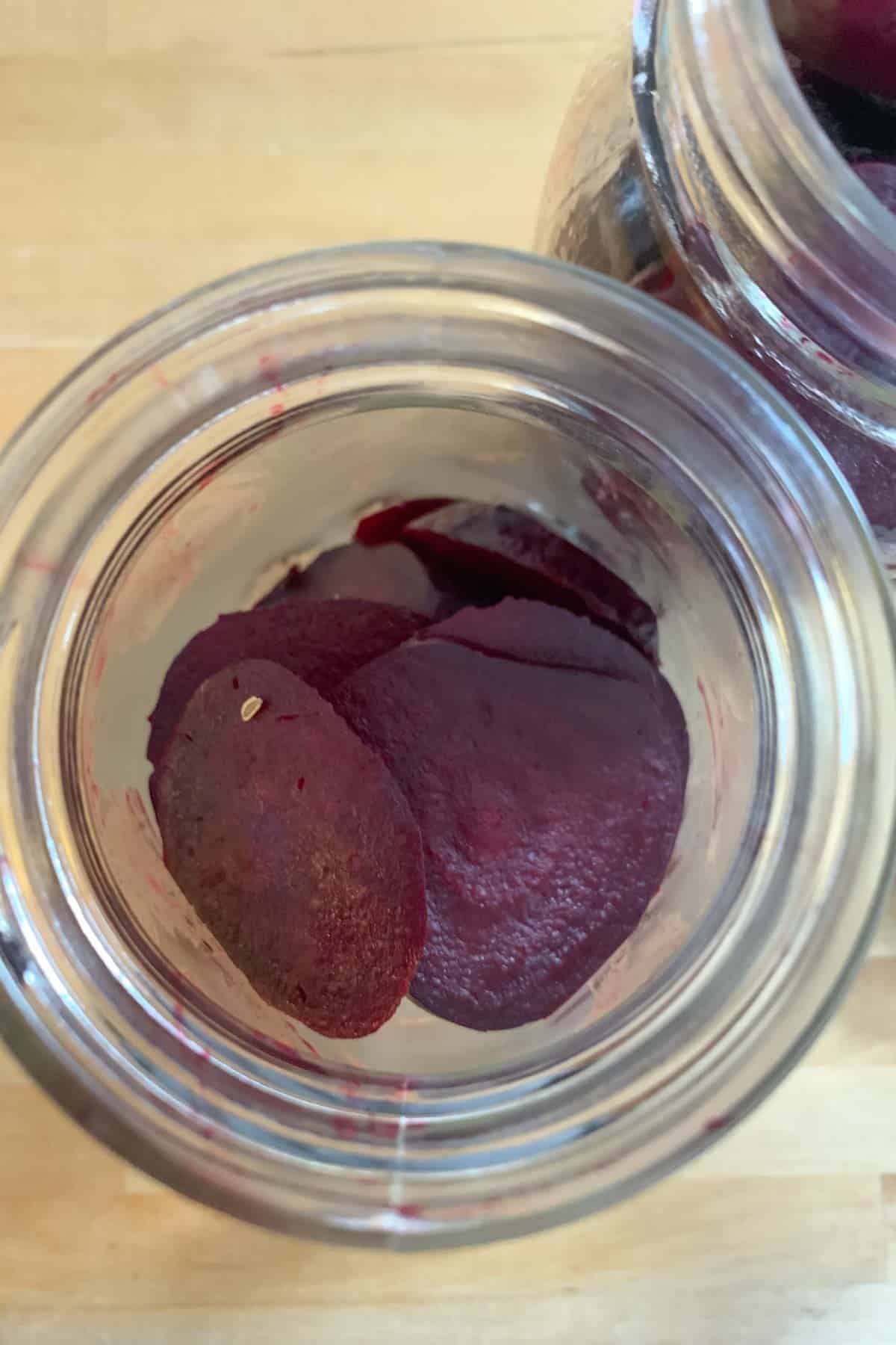 Filling jars with sliced roasted beets.