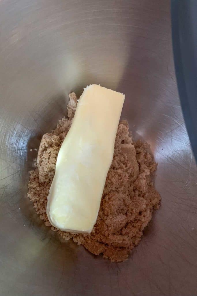 Brown sugar and butter in a mixing bowl.