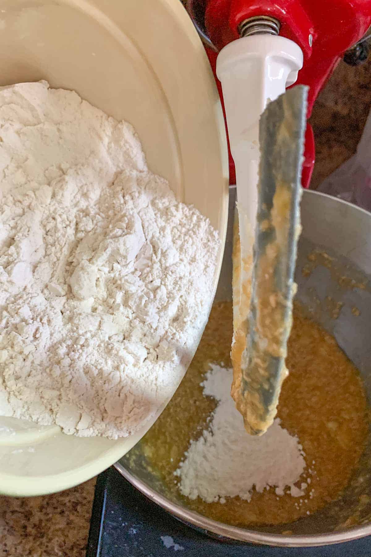 Adding flour mixture to banana bread batter.