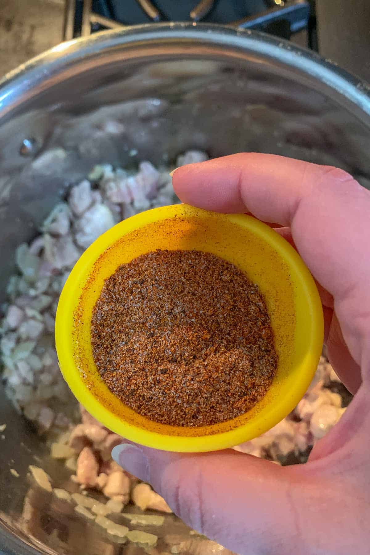 Adding mixed spices to stock pot.
