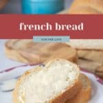 A slice of french bread spread with butter rests on a plate, while more fresh french bread and a butter knife appear in the background.