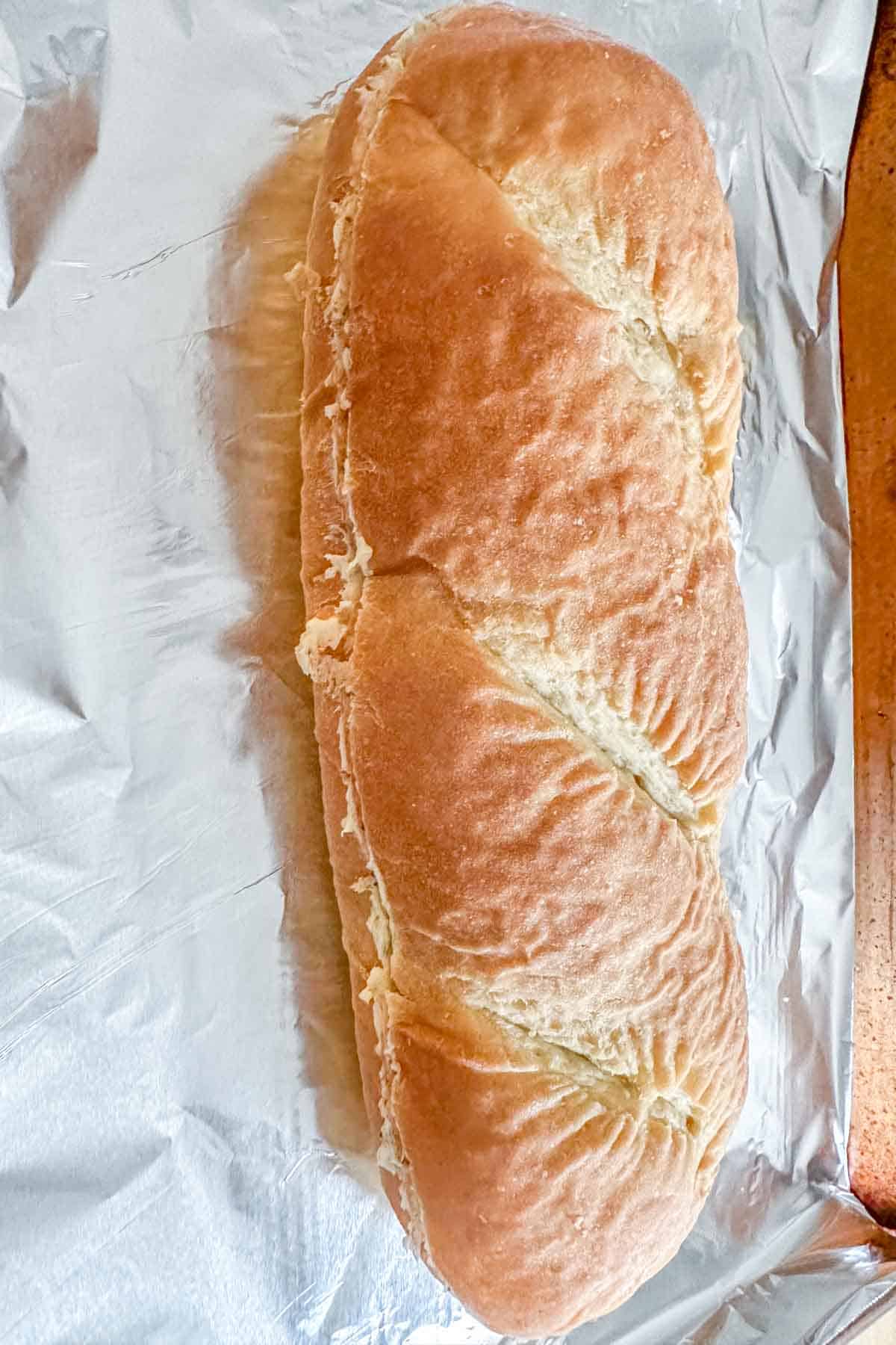 Loaf of garlic bread sandwiched together before baking.