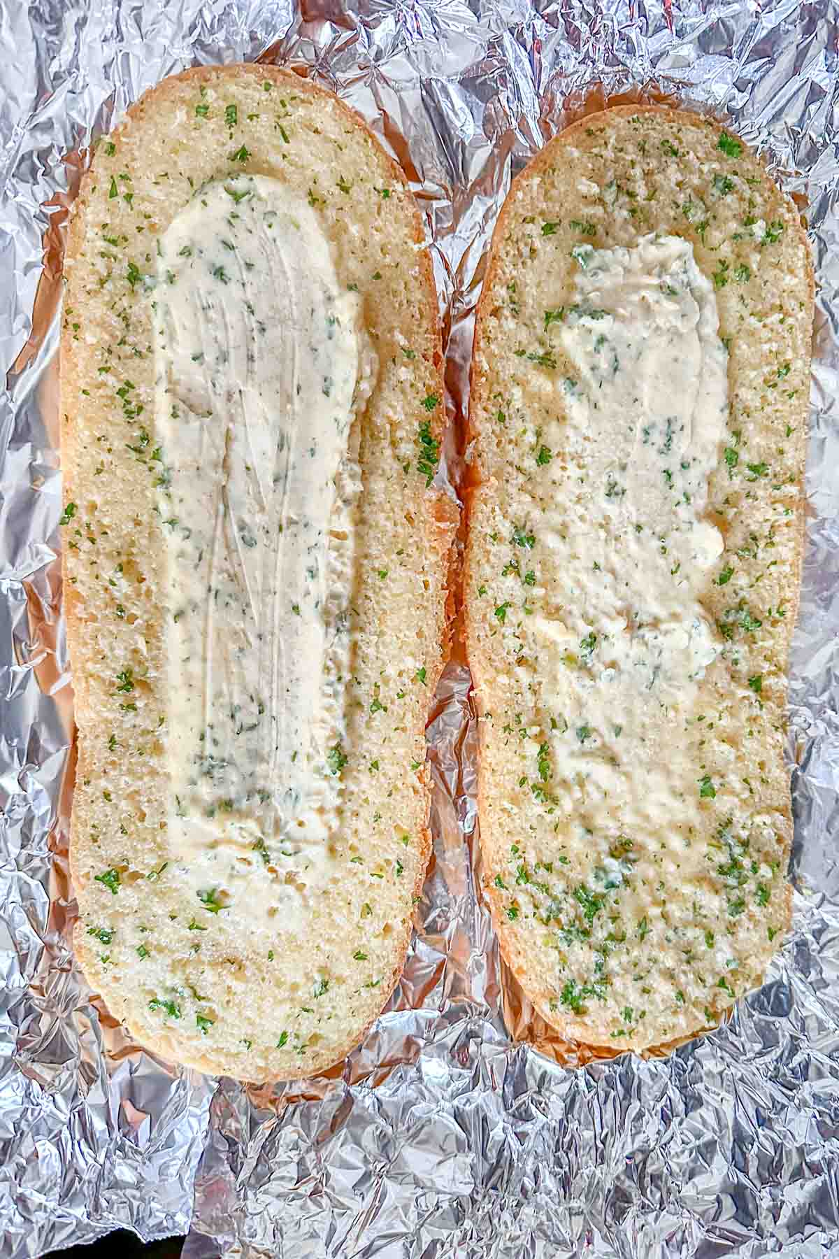 Parbaked garlic bread on foil.