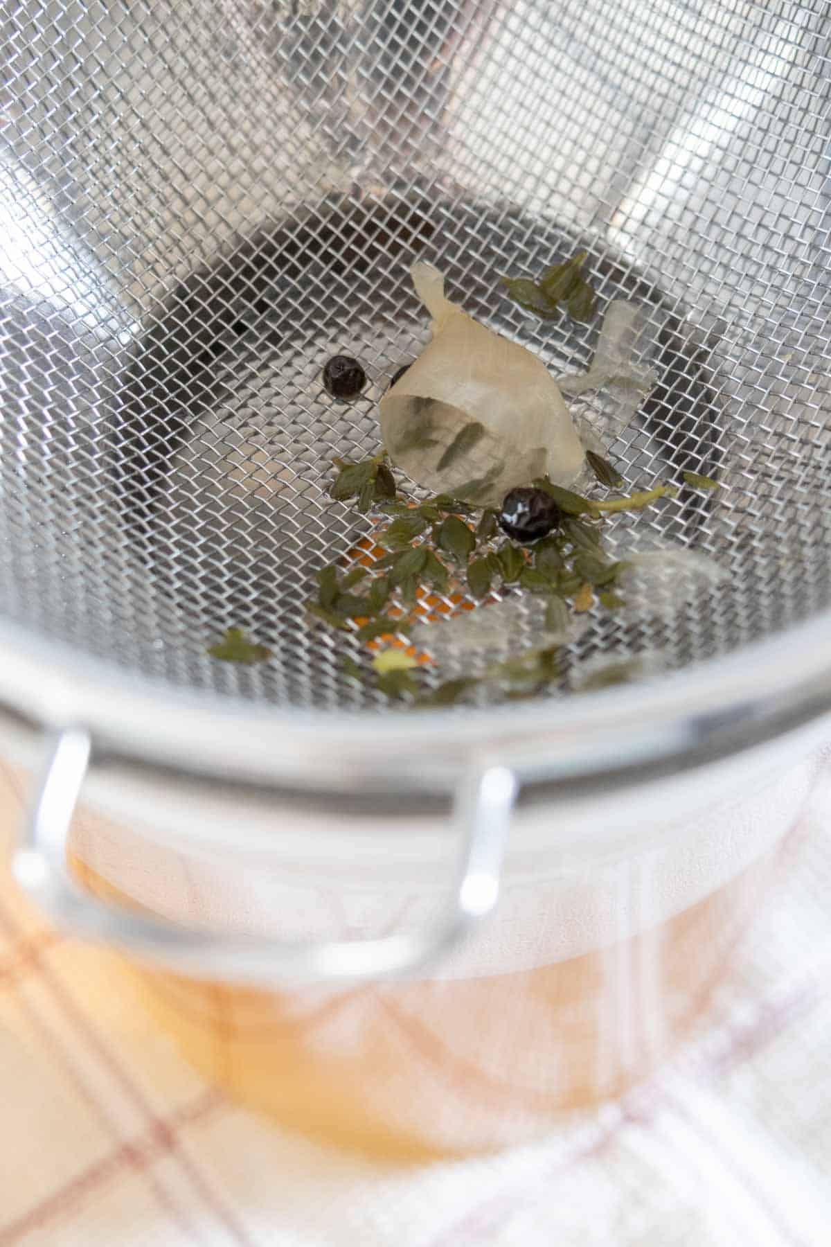Strainer set over container for straining vegetable stock.