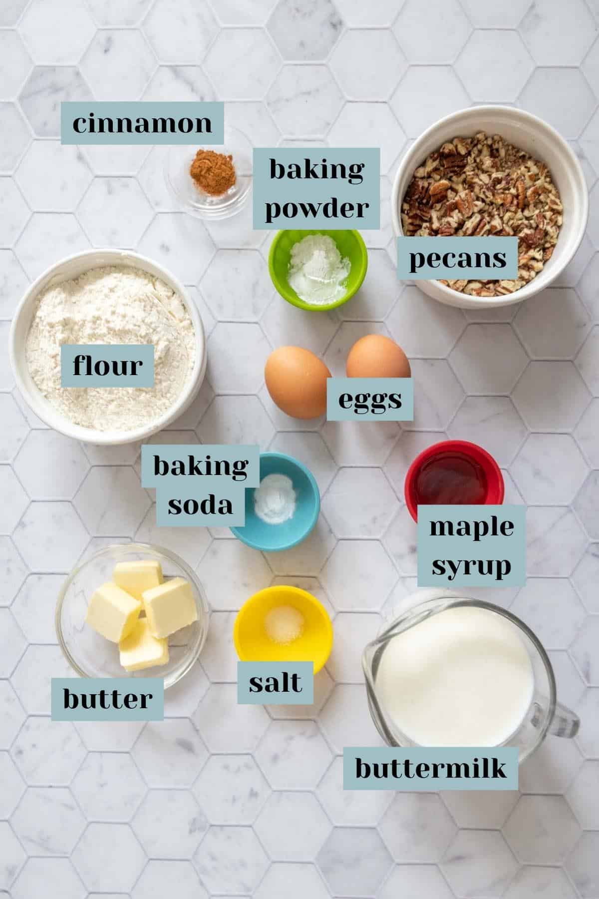 Ingredients for pecan pancakes on a tile surface with labels.