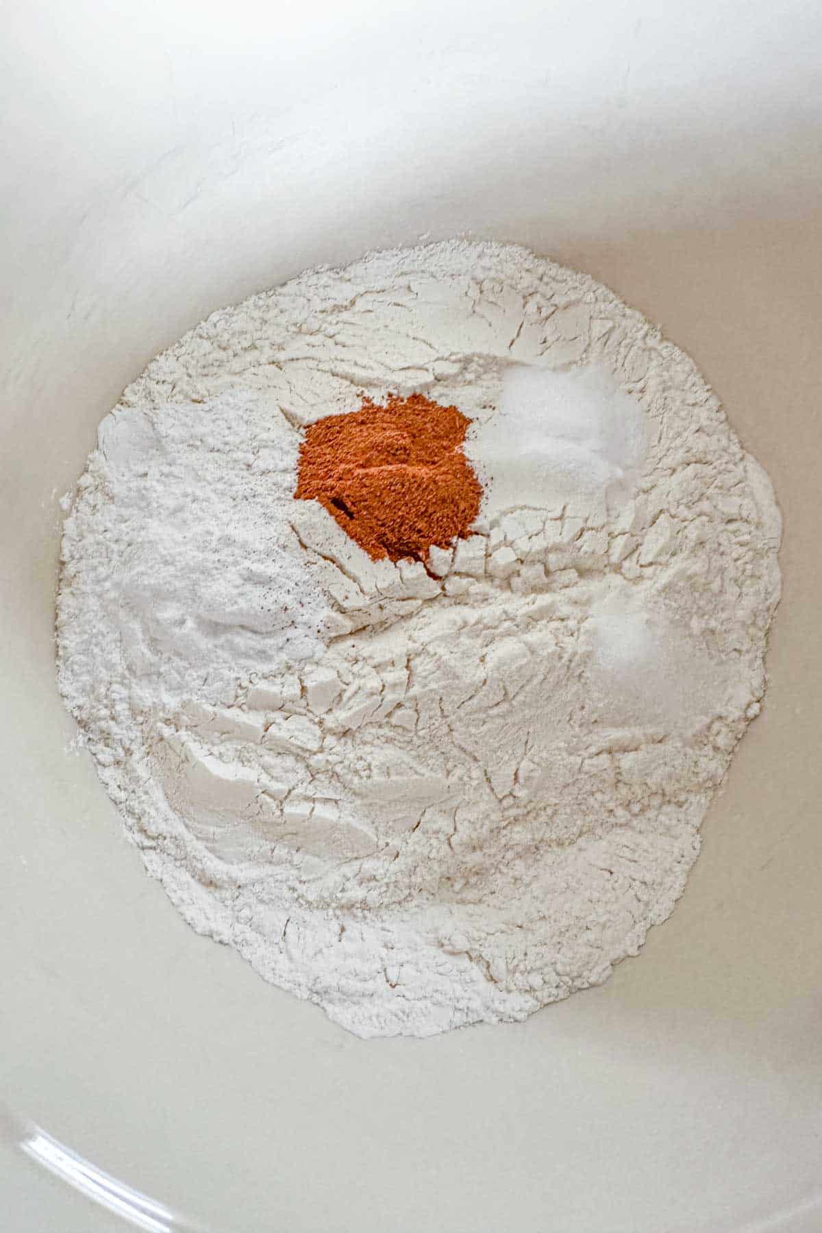 Dry ingredients for pecan pancakes in a mixing bowl.