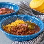 Blue enamel bowl of bison chili.