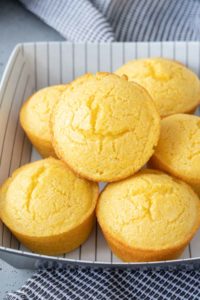 Baked corn muffins in a serving dish.