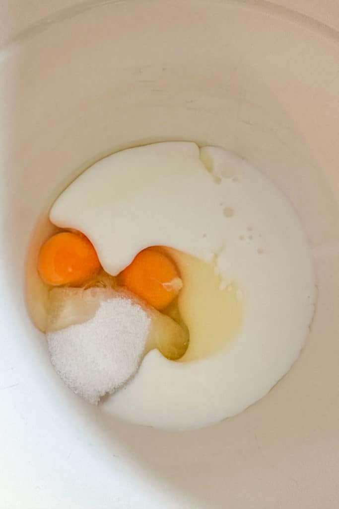 Mixing bowl containing sugar, eggs, and buttermilk.